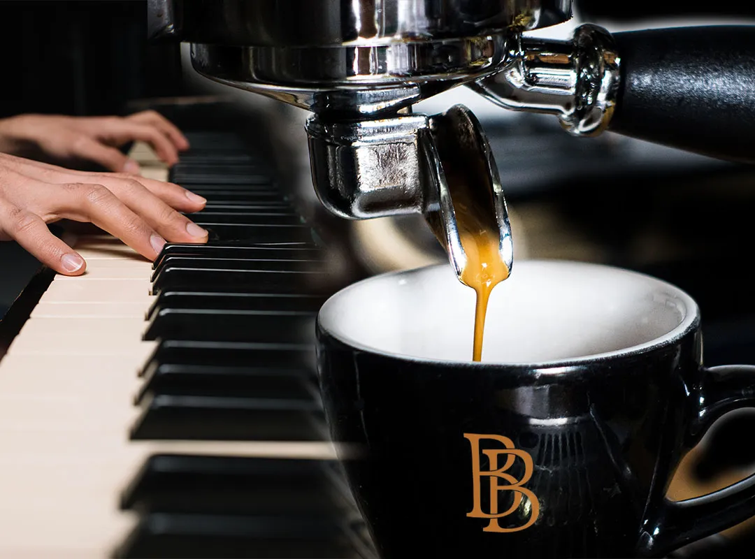 Espresso pouring beside piano keys